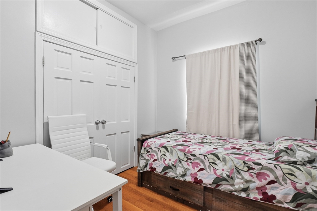 1661 North Shore Road Revere, MA 02151 - Photo 19 of 42 a bedroom with a bed and a dresser
