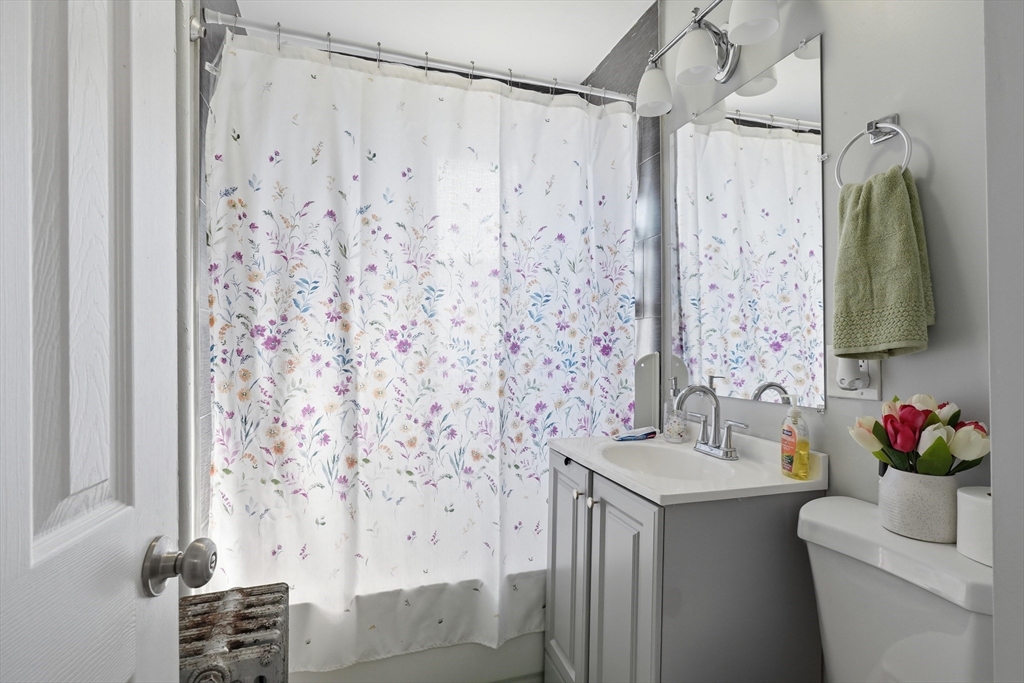 1661 North Shore Road Revere, MA 02151 - Photo 20 of 42 a bathroom with a sink and a mirror
