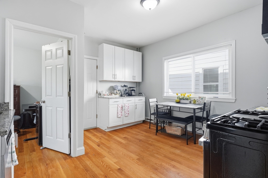 1661 North Shore Road Revere, MA 02151 - Photo 22 of 42 a kitchen with a stove a refrigerator and a dining table