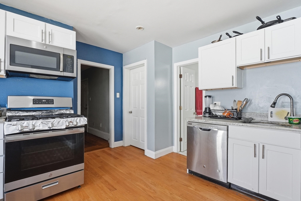 1661 North Shore Road Revere, MA 02151 - Photo 30 of 42 a kitchen with stainless steel appliances granite countertop a stove microwave and sink