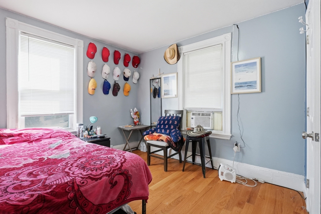 1661 North Shore Road Revere, MA 02151 - Photo 31 of 42 a bedroom with a bed and a table in it with window