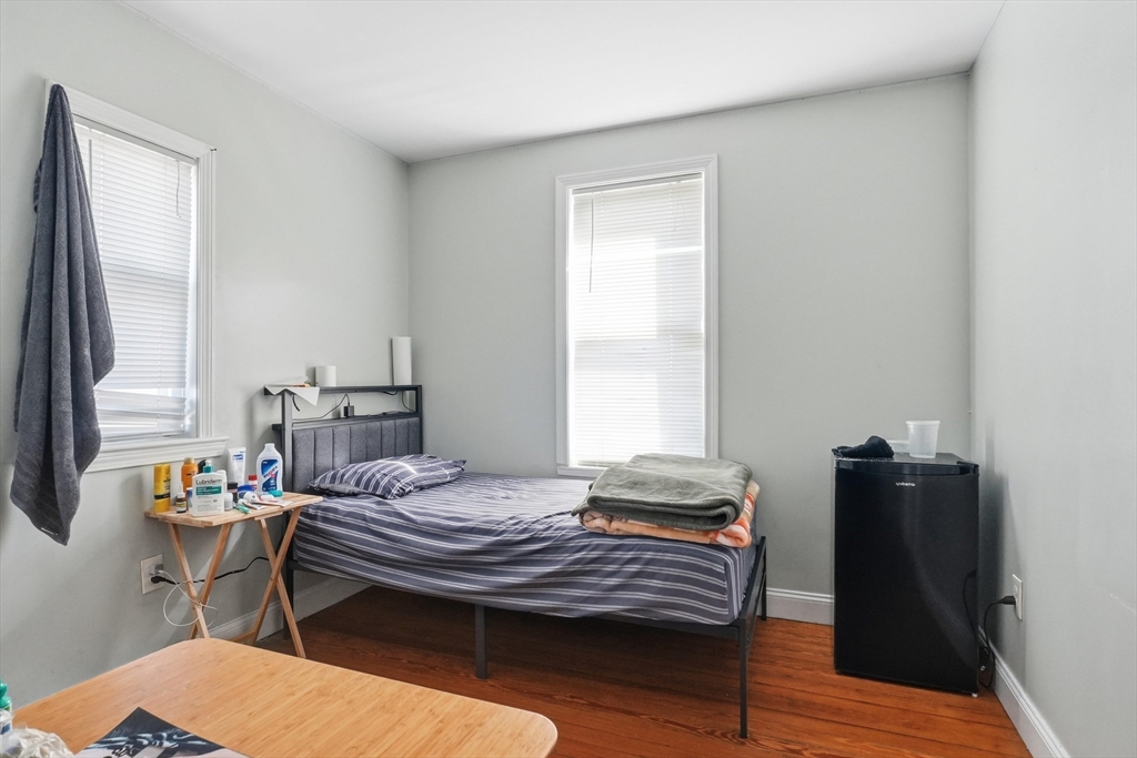 1661 North Shore Road Revere, MA 02151 - Photo 33 of 42 a bedroom with a bed and wooden floor