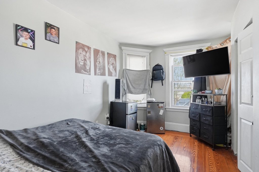 1661 North Shore Road Revere, MA 02151 - Photo 34 of 42 a bedroom with a bed and a flat screen tv