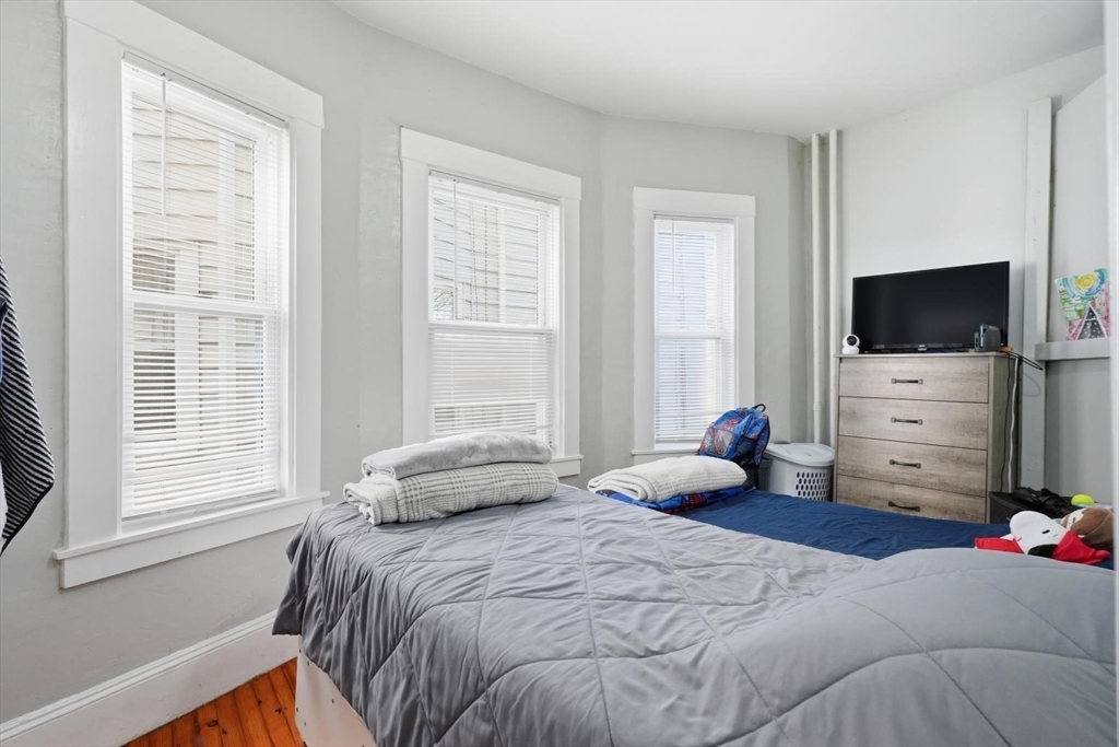 1661 North Shore Road Revere, MA 02151 - Photo 39 of 42 a bedroom with a bed and a flat screen tv