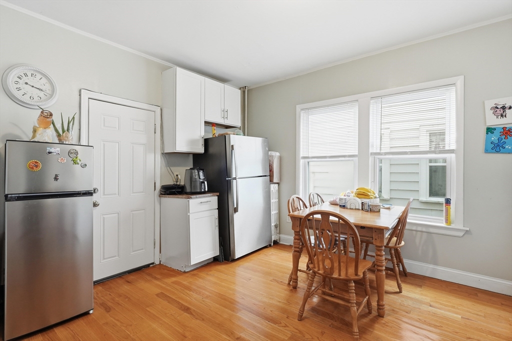 1661 North Shore Road Revere, MA 02151 - Photo 5 of 42 a kitchen with stainless steel appliances a refrigerator a stove a dining table and chairs