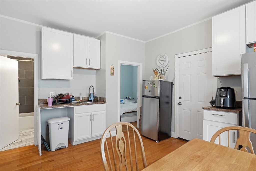 1661 North Shore Road Revere, MA 02151 - Photo 6 of 42 a kitchen with stainless steel appliances granite countertop a refrigerator a stove top oven a sink and dishwasher