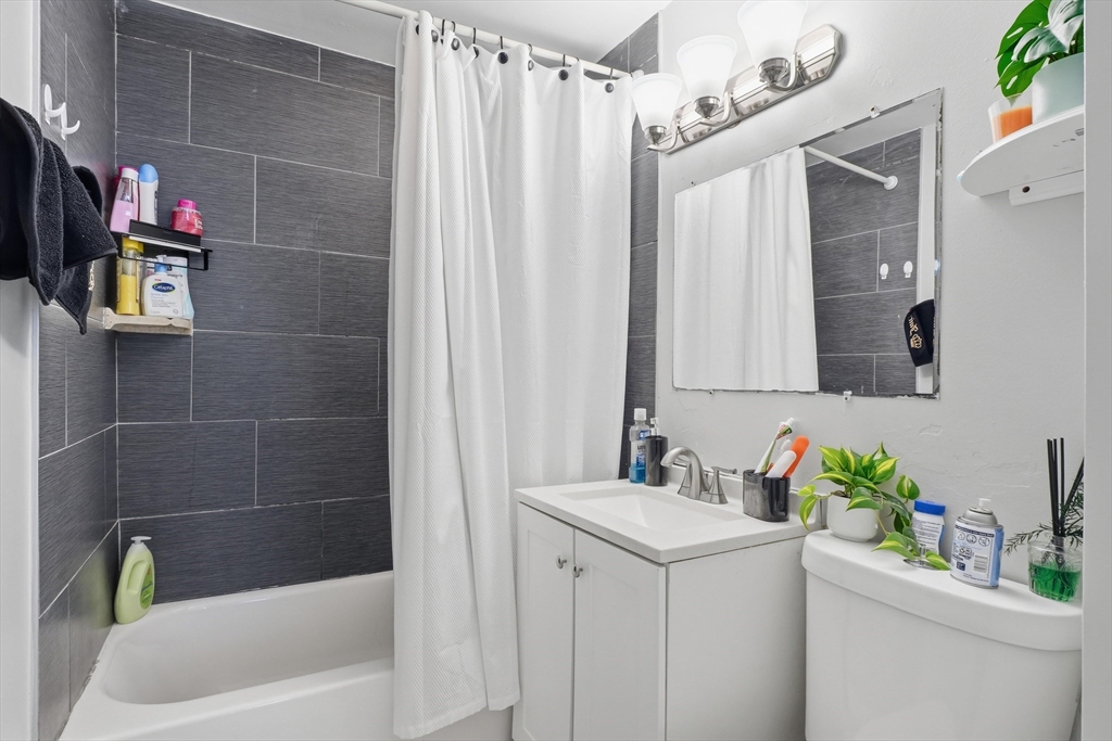 1661 North Shore Road Revere, MA 02151 - Photo 8 of 42 a bathroom with a sink toilet and shower