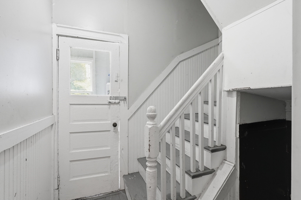 1661 North Shore Road Revere, MA 02151 - Photo 10 of 42 a view of staircase with white walls and a window