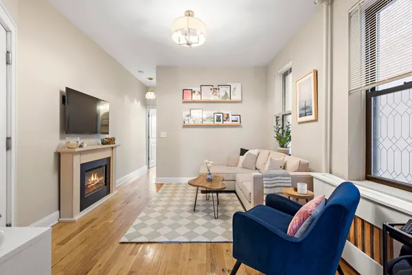 a living room with furniture a fireplace and a flat screen tv