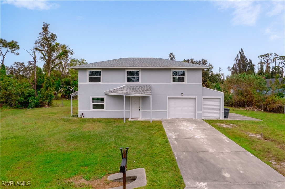 8025 Anhinga Road Fort Myers, FL 33967 - Photo 1 of 47 a front view of a house with a yard