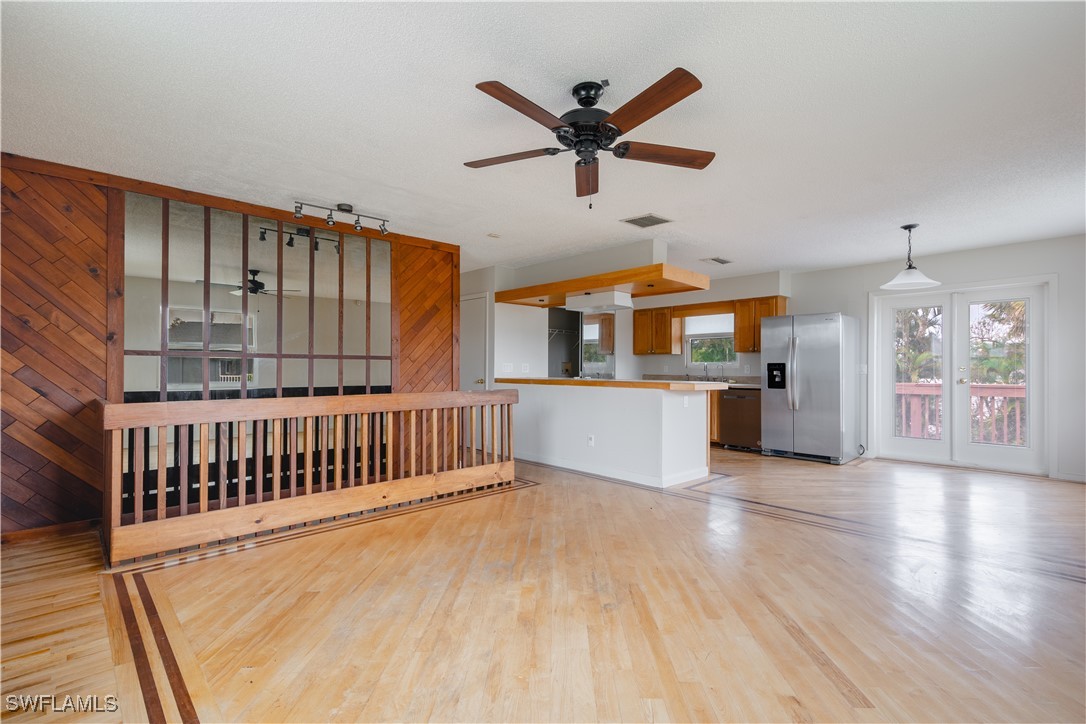 8025 Anhinga Road Fort Myers, FL 33967 - Photo 16 of 47 a view of a big room with wooden floor and windows