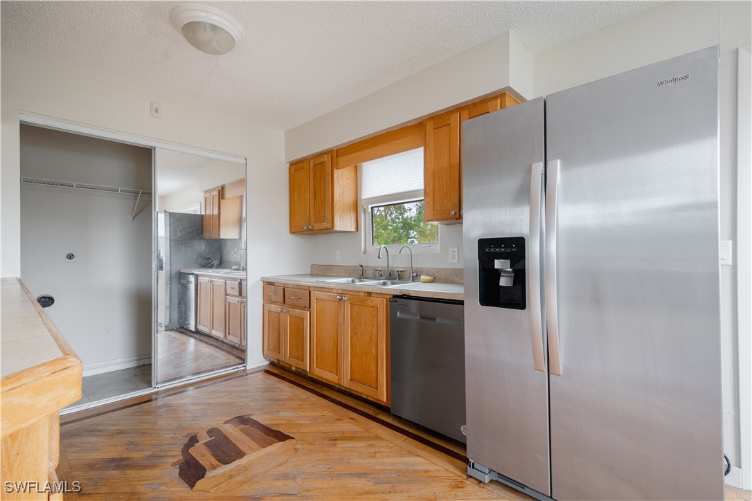 8025 Anhinga Road Fort Myers, FL 33967 - Photo 20 of 47 a kitchen with stainless steel appliances granite countertop a refrigerator and a sink