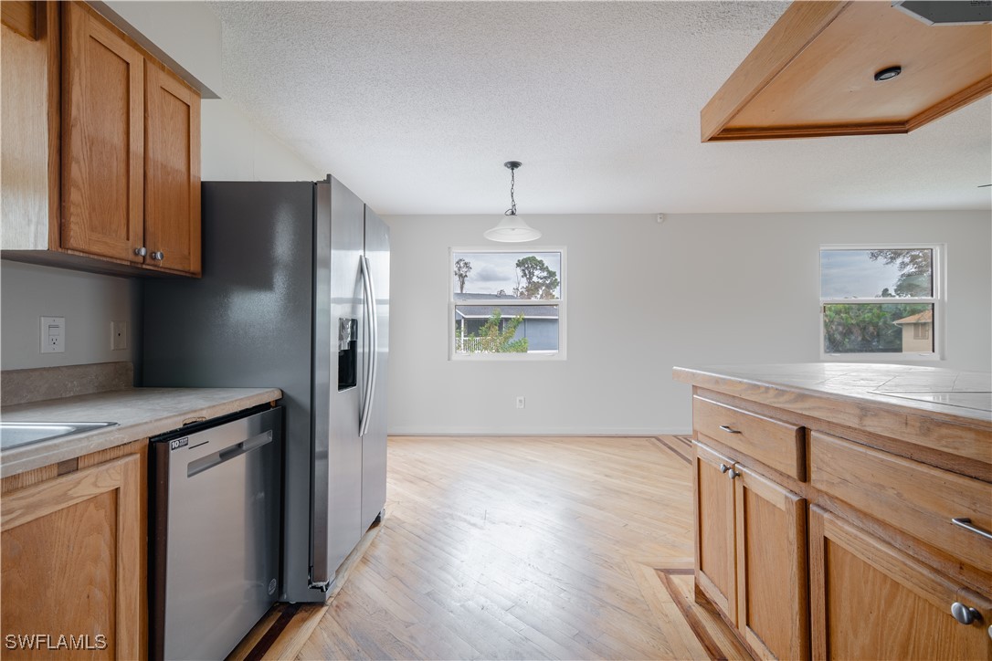 8025 Anhinga Road Fort Myers, FL 33967 - Photo 22 of 47 a kitchen with granite countertop cabinets stainless steel appliances a sink and a window