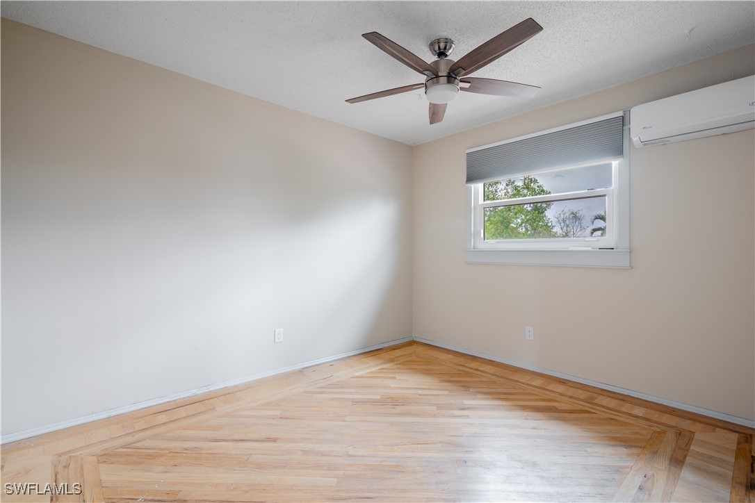 8025 Anhinga Road Fort Myers, FL 33967 - Photo 25 of 47 an empty room with wooden floor and ceiling fan