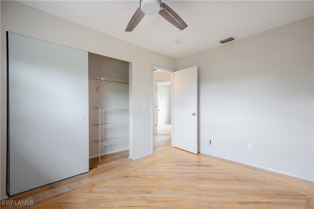 8025 Anhinga Road Fort Myers, FL 33967 - Photo 26 of 47 a view of empty room with wooden floor and ceiling fan