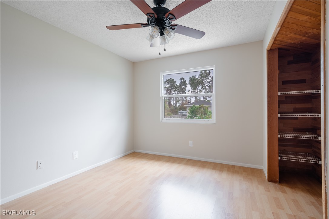 8025 Anhinga Road Fort Myers, FL 33967 - Photo 27 of 47 an empty room with a chandelier fan and windows