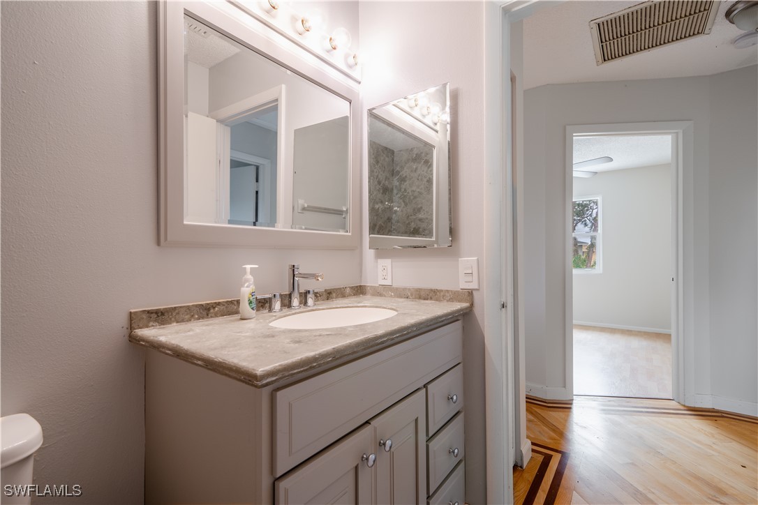 8025 Anhinga Road Fort Myers, FL 33967 - Photo 30 of 47 a bathroom with a granite countertop sink and a mirror