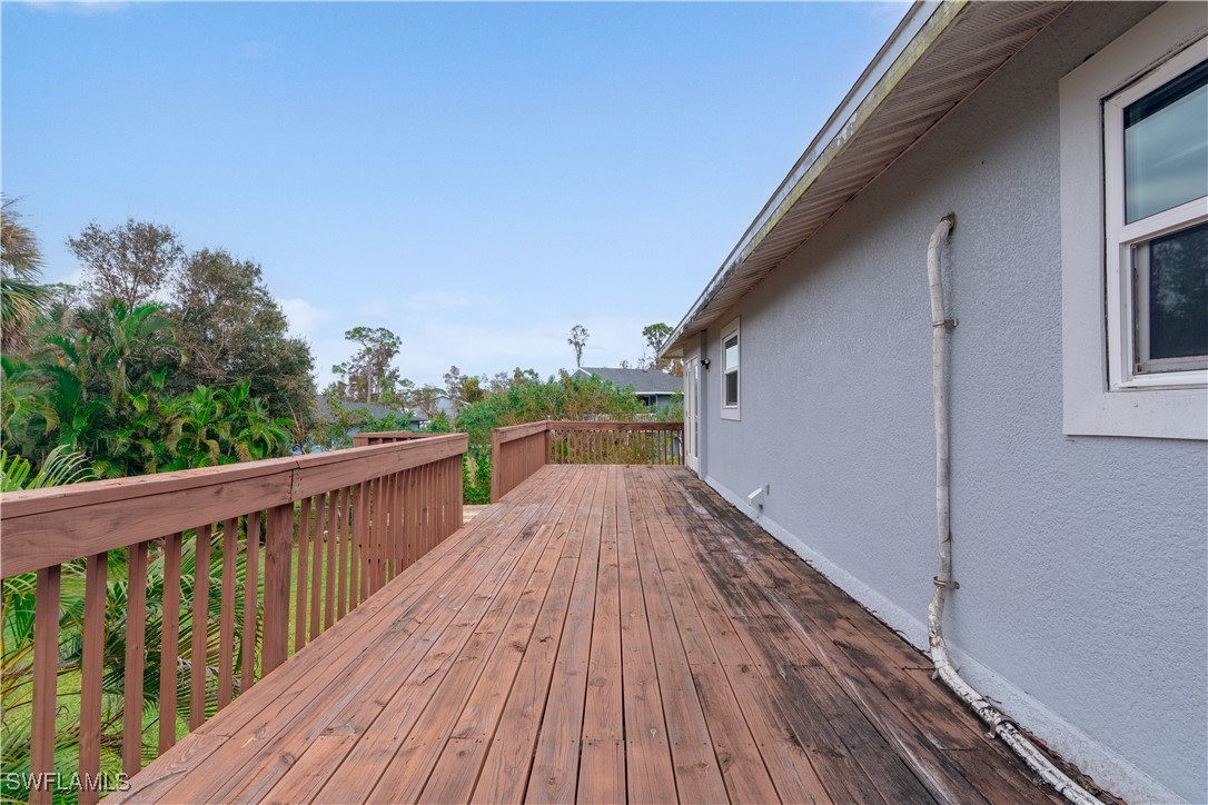 8025 Anhinga Road Fort Myers, FL 33967 - Photo 33 of 47 a view of balcony with wooden floor and fence