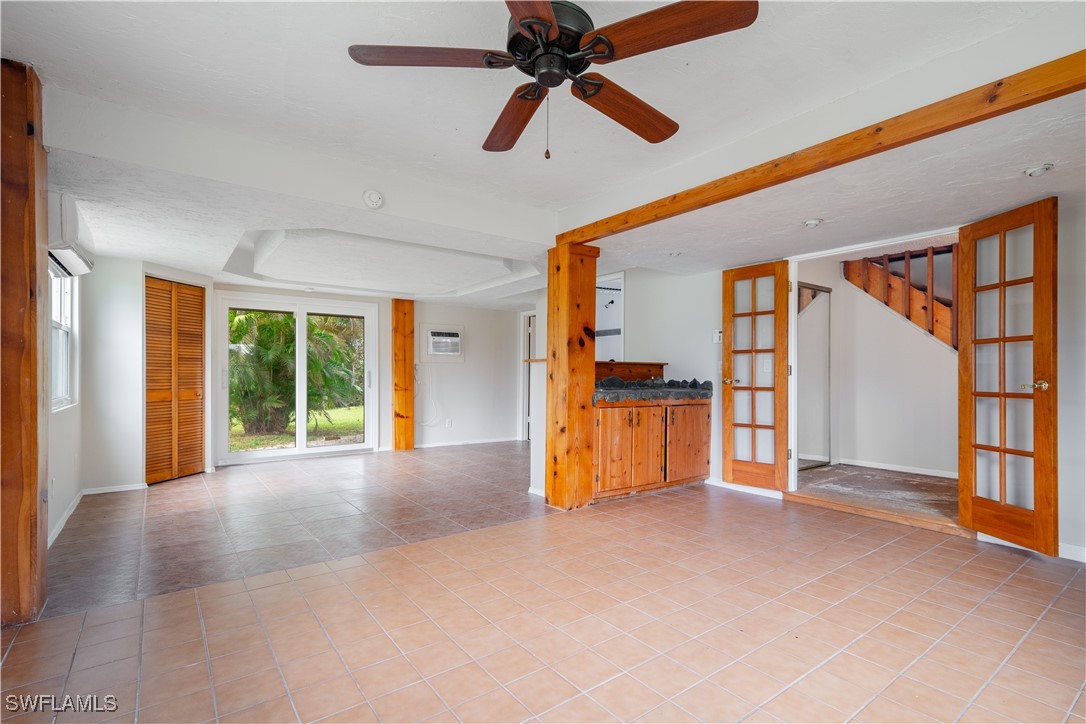 8025 Anhinga Road Fort Myers, FL 33967 - Photo 4 of 47 a view of empty room with wooden floor and fan