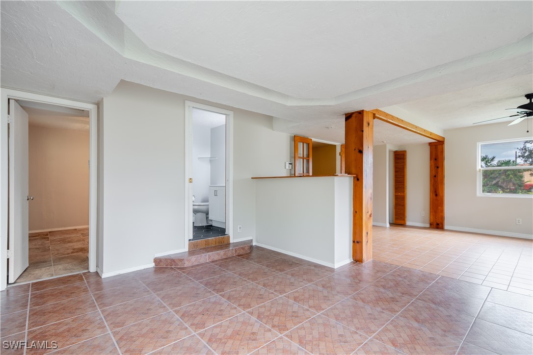 8025 Anhinga Road Fort Myers, FL 33967 - Photo 6 of 47 a view of empty room with kitchen and windows
