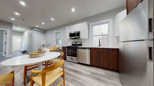 a kitchen with a refrigerator and a stove top oven