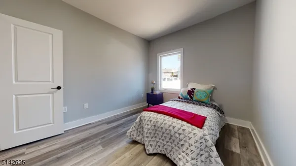 a bedroom with a bed and window