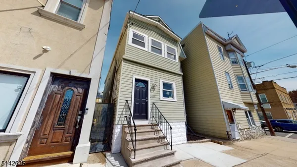 a front view of a house with stairs