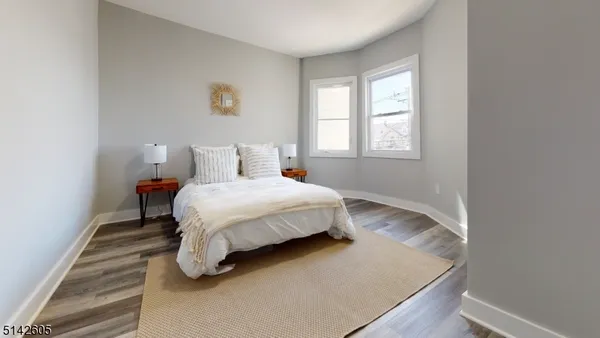 a bed sitting in a bedroom next to a window