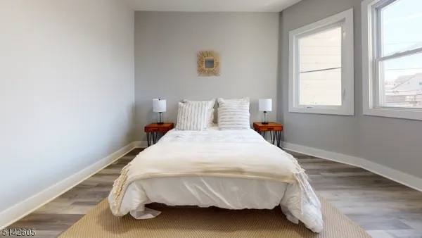 a bed sitting in a bedroom next to a window