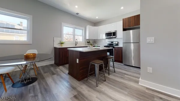 a view of kitchen with dining table and chairs
