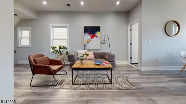 a living room with furniture and a potted plant