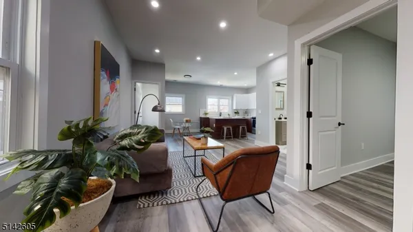 a living room with furniture and a potted plant