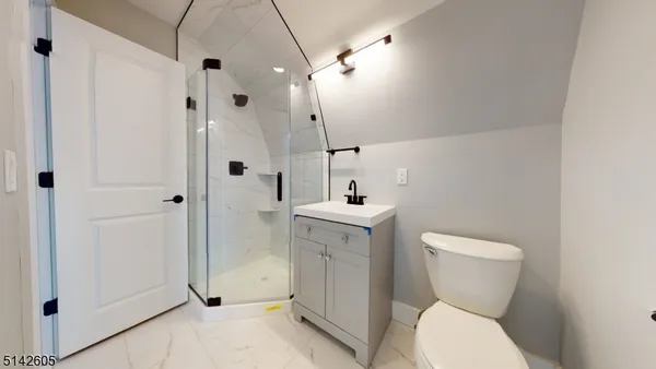 a bathroom with a toilet sink and shower