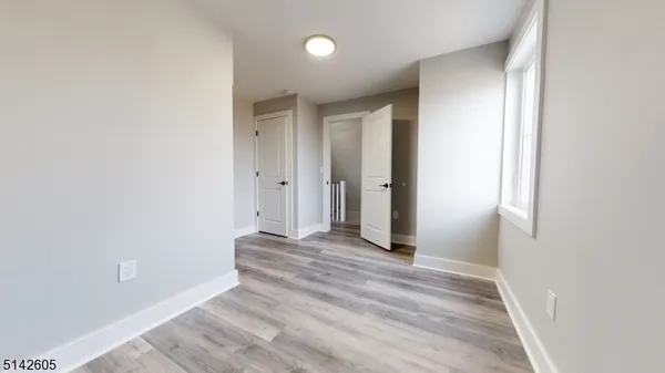 a view of a room with wooden floor
