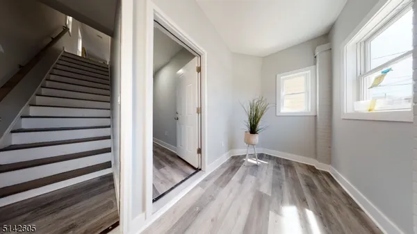 a view of a hallway view with wooden floor and staircase