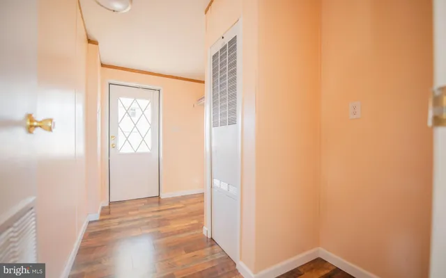 a view of empty room with wooden floor and windows