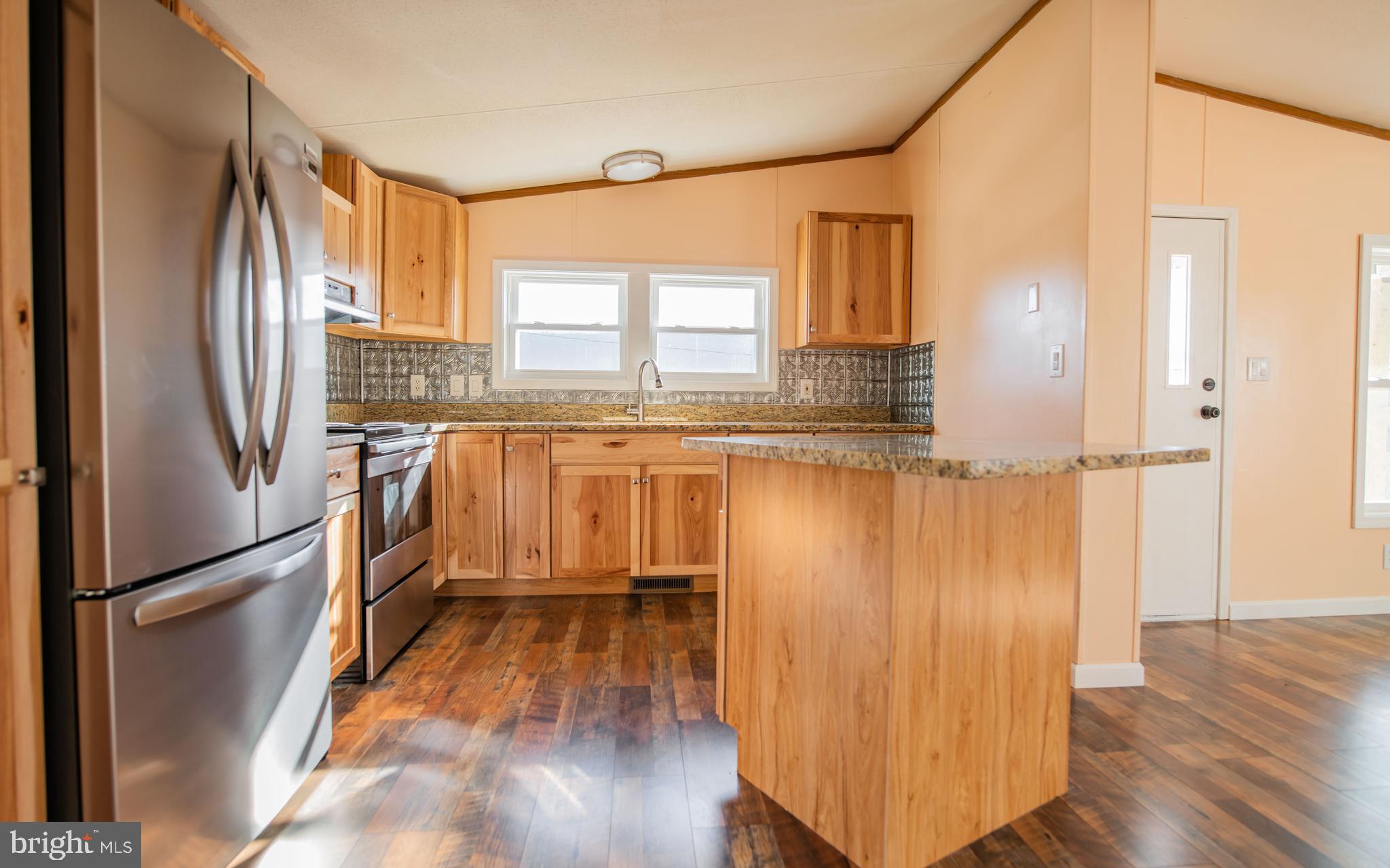 937 Center Street Lock Haven, PA 17745 - Photo 4 of 20 a kitchen with granite countertop a refrigerator a sink and wooden floor