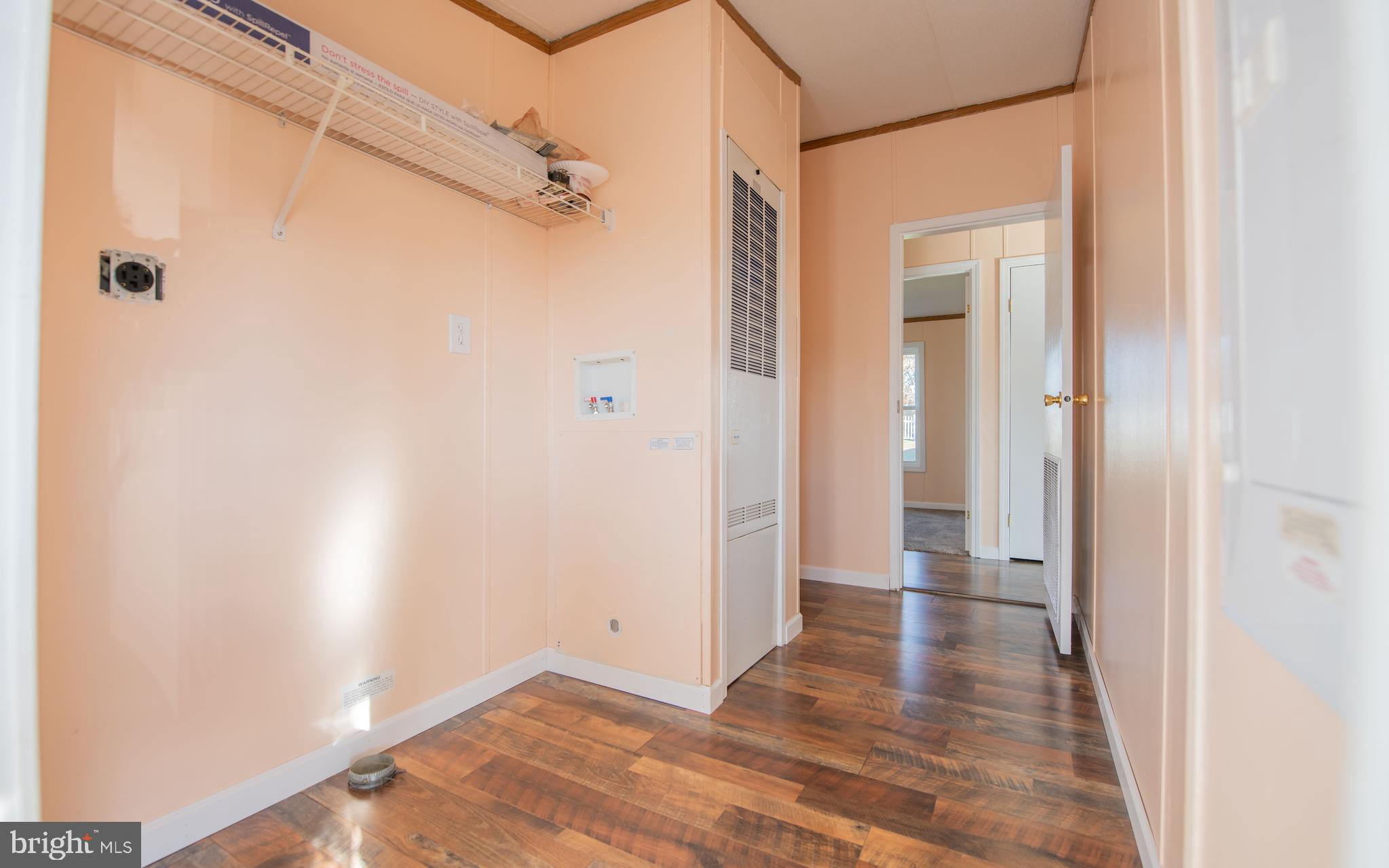937 Center Street Lock Haven, PA 17745 - Photo 7 of 20 a view of a hallway with wooden floor and a bathroom