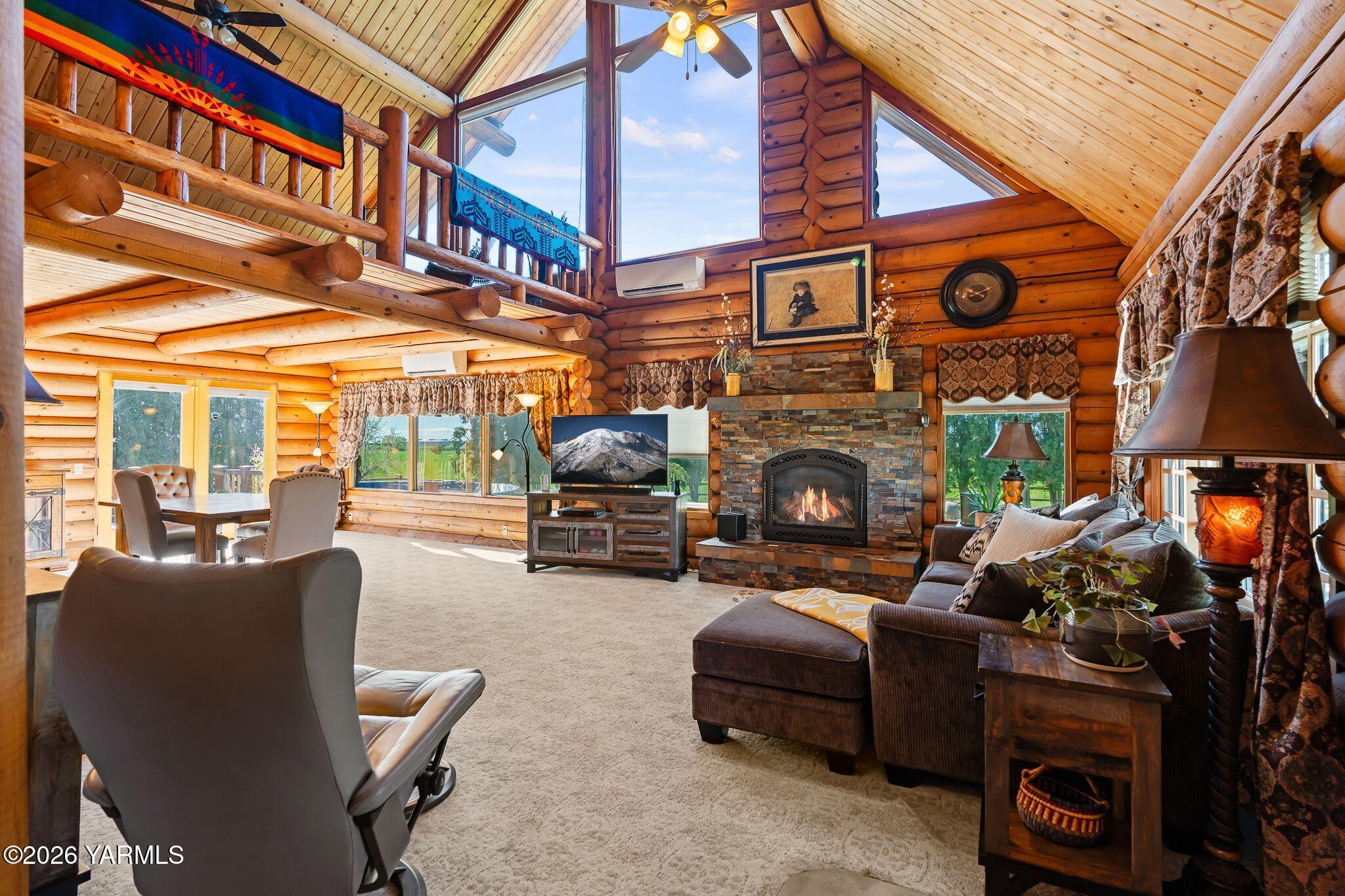 2550 Kays Road Wapato, WA 98951 - Photo 6 of 52 a living room with furniture a fireplace and a chandelier