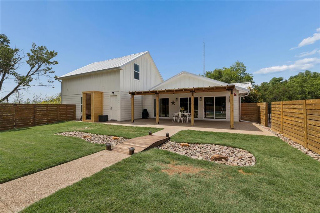 286 Benevolence Way China Spring, TX 76633 - Photo 26 of 37 Expansive backyard with a gravel pathway, a wooden bridge, and a rock garden feature