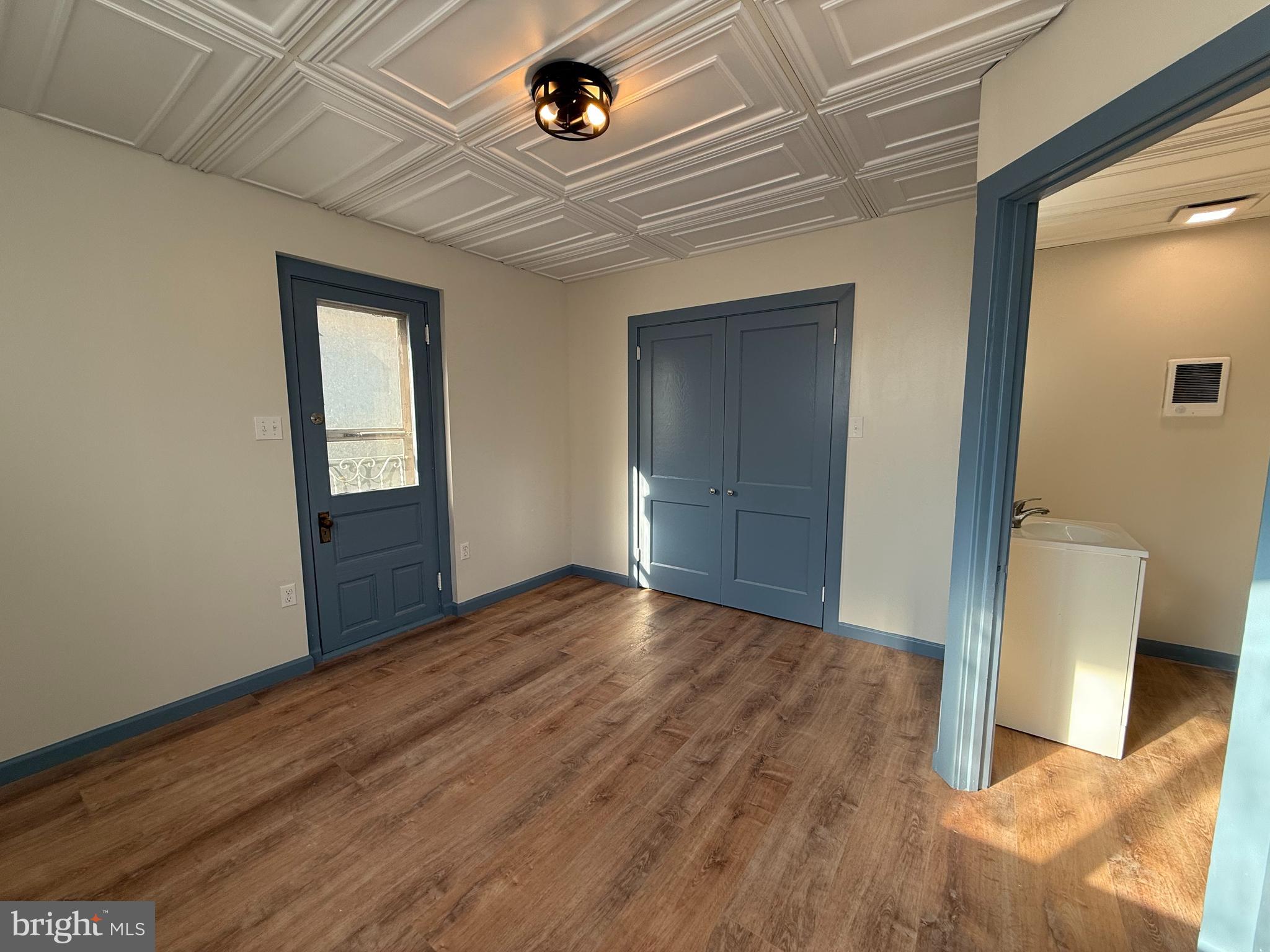 5036-3 Leesport Avenue Temple, PA 19560 - Photo 4 of 9 a view of an empty room with wooden floor and a window