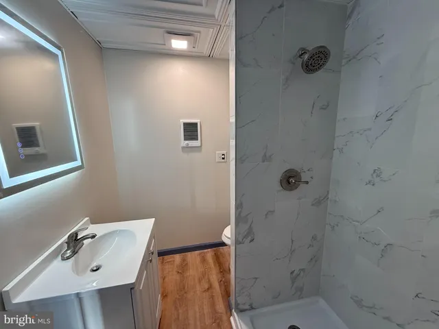 a bathroom with a sink toilet and shower