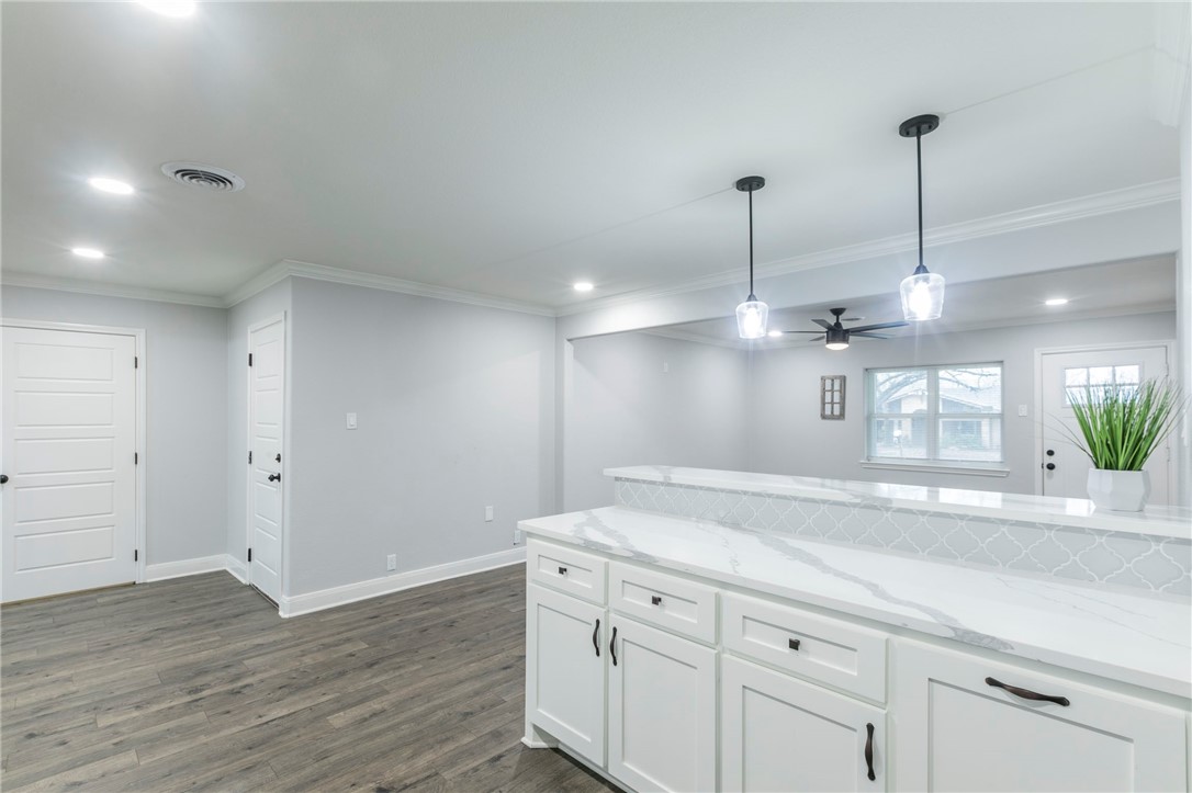 105 Alamo Drive McGregor, TX 76657 - Photo 12 of 34 a view of a kitchen island a sink and wooden floor