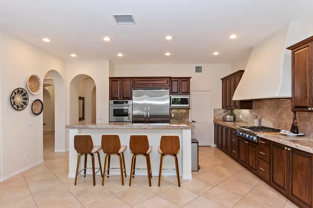 a kitchen with cabinets and chairs