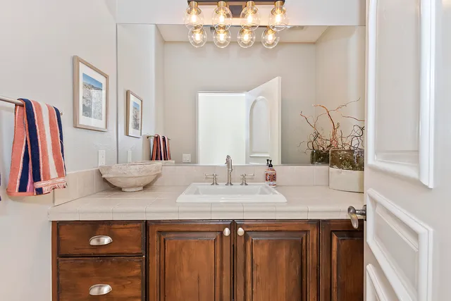 a bathroom with a sink vanity and a mirror
