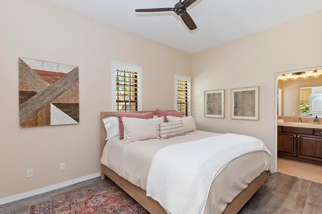 a bedroom with a large bed and a window