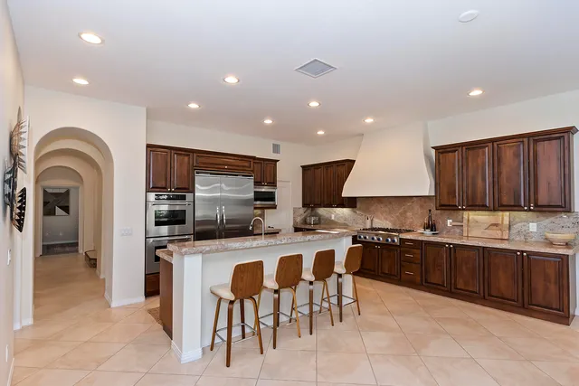 a kitchen with lots of counter top space cabinets and stainless steel appliances