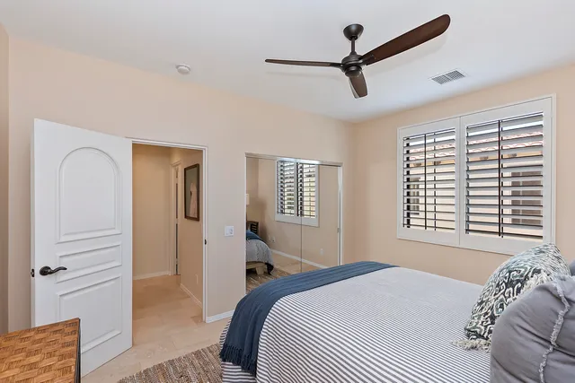 a bedroom with a bed a dresser and a window