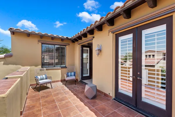 a building outdoor space with patio furniture and potted plants