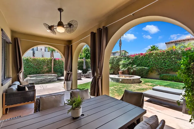 a view of a porch with furniture and yard